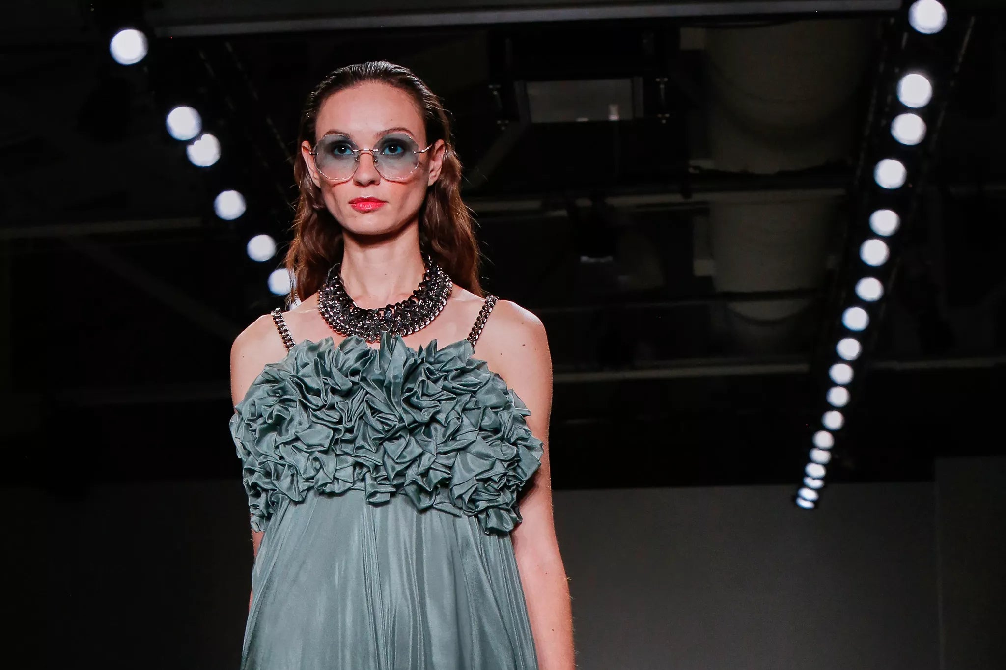 Model wearing a made in Italy luxury resortwear dress with ruffled bodice by FRAQAIR.