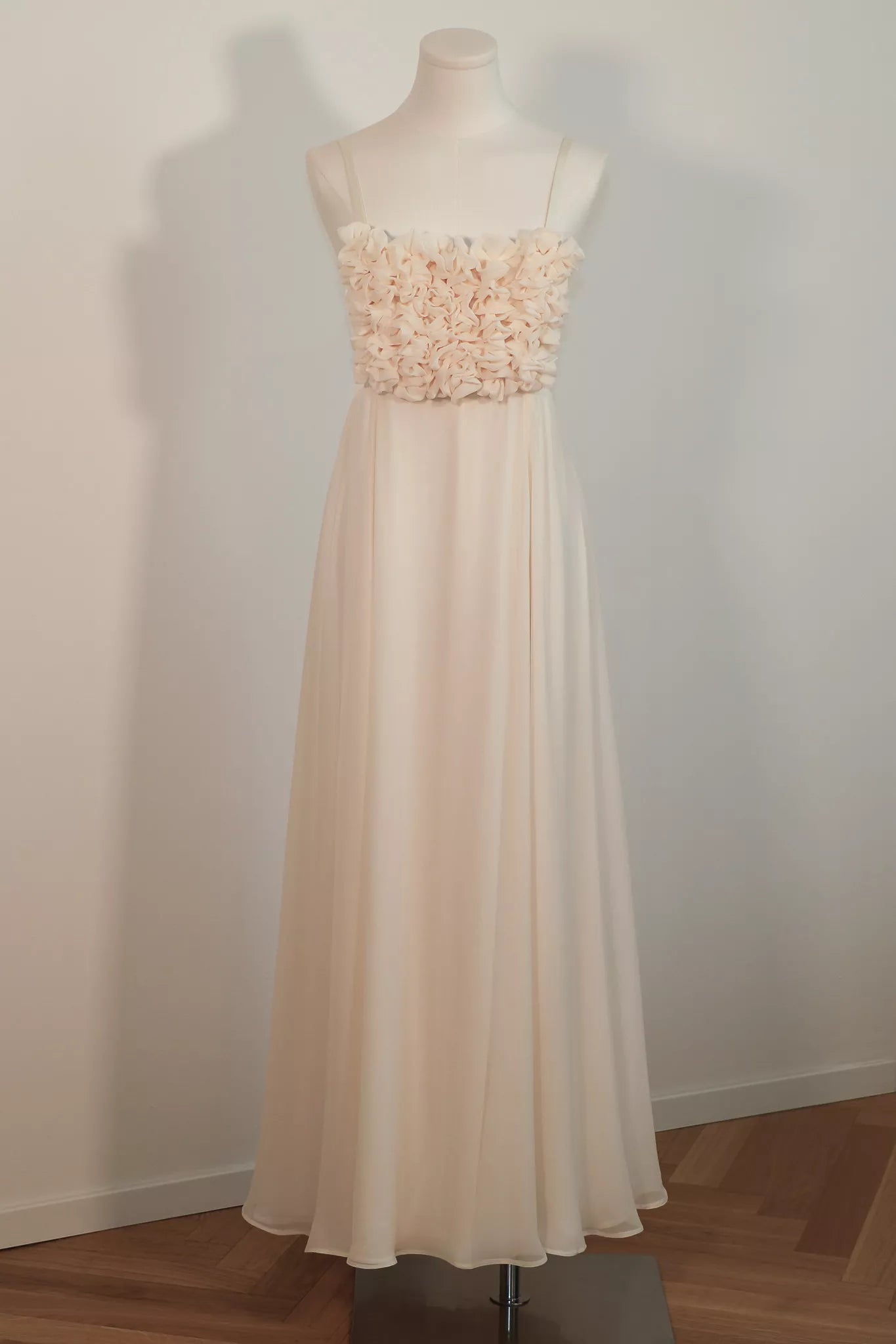 Aria silk chiffon wedding dress on a dress form in the Milan atelier, front view